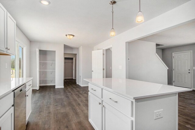7942 Sierra Dr, Belding, MI 48809 - kitchen with dark wood finished floors, white cabinets, stainless steel dishwasher, and light countertops