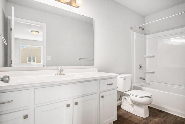 7942 Sierra Dr, Belding, MI 48809 - bathroom with toilet, bathing tub / shower combination, wood finished floors, and vanity