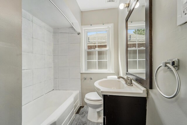 full bathroom featuring vanity, toilet, and tiled shower / bath combo