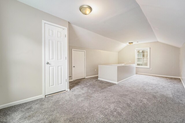 bonus room with carpet and vaulted ceiling