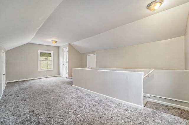 bonus room with carpet and lofted ceiling