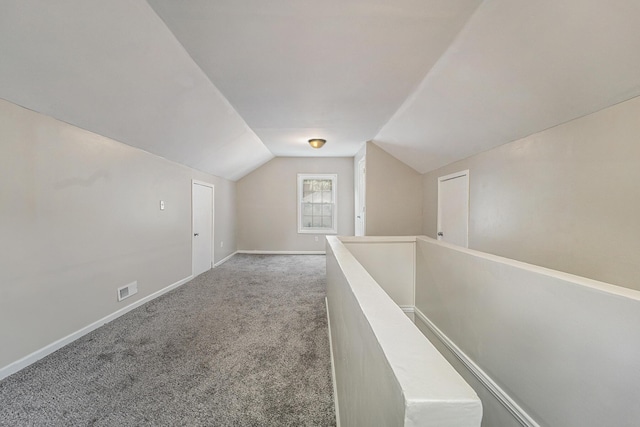 bonus room with carpet floors and vaulted ceiling