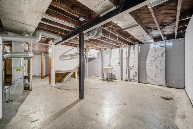 basement with heating unit and sink