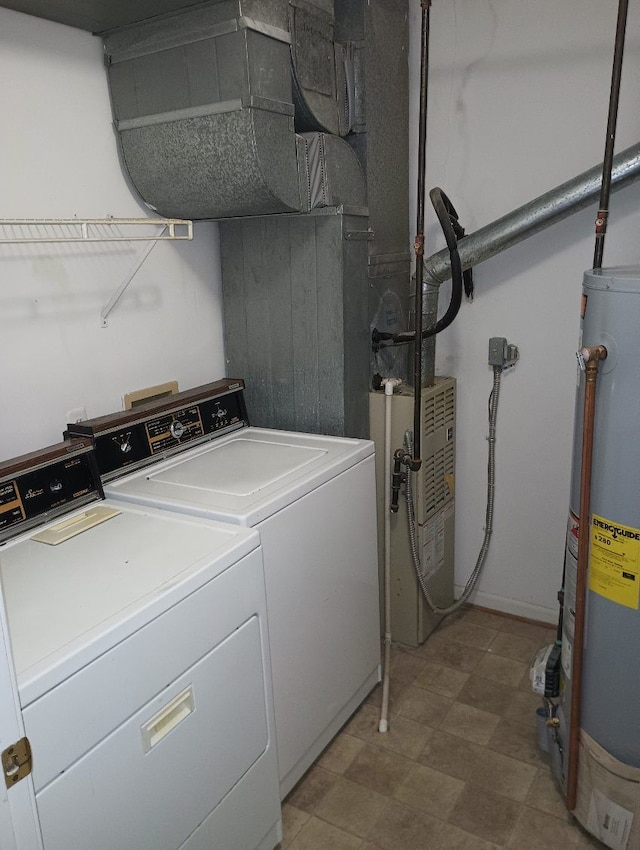 clothes washing area featuring washer and dryer and gas water heater