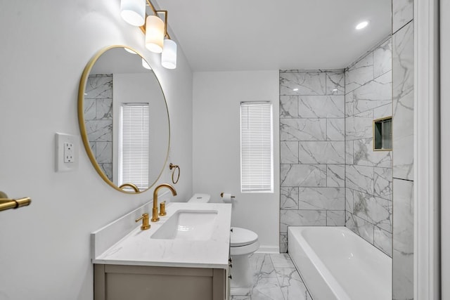 full bathroom with vanity, toilet, and tiled shower / bath combo