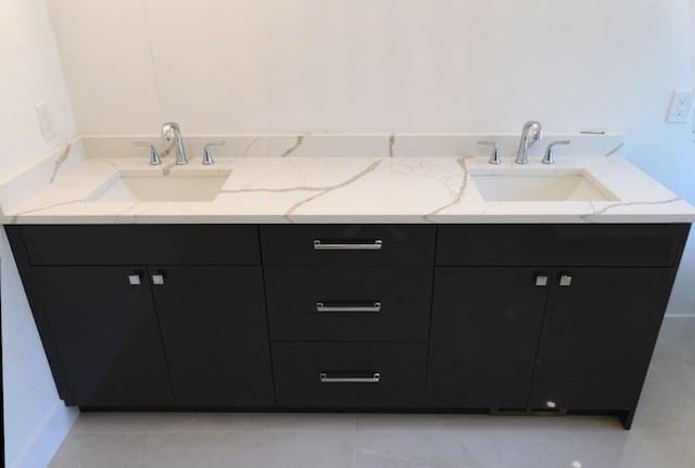 bathroom with tile patterned floors and vanity