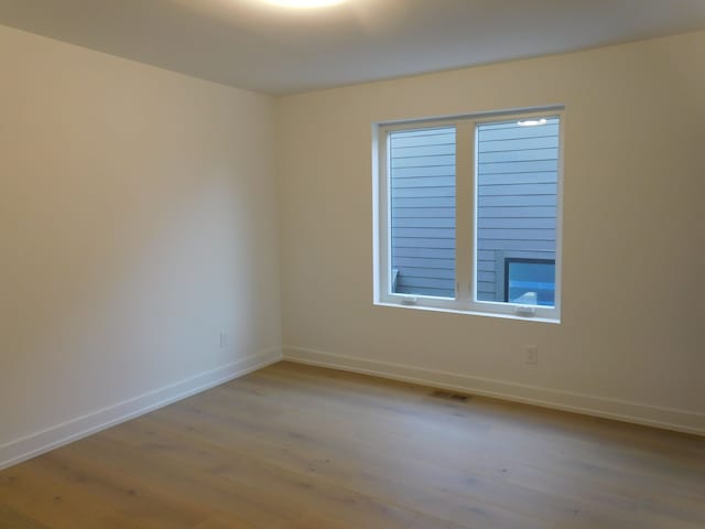 spare room with light wood-type flooring