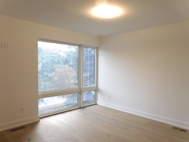 empty room with light hardwood / wood-style flooring