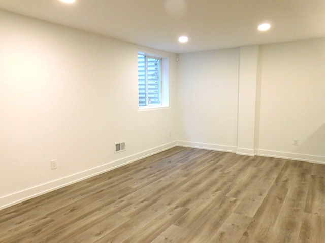 unfurnished room with hardwood / wood-style flooring