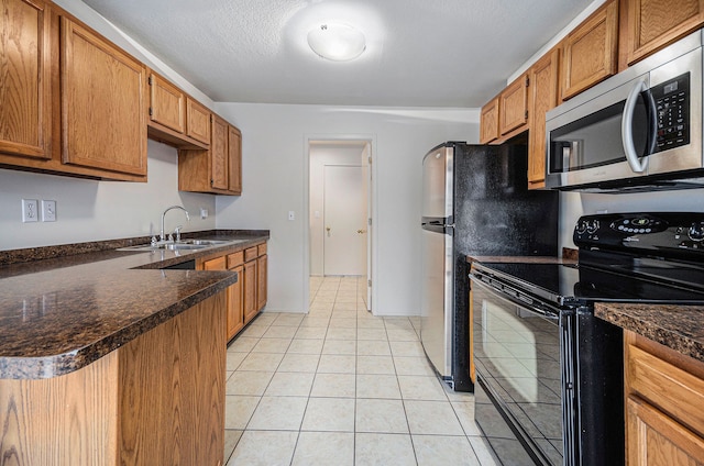 kitchen featuring kitchen peninsula, black range with electric cooktop, a textured ceiling, sink, and light tile patterned floors