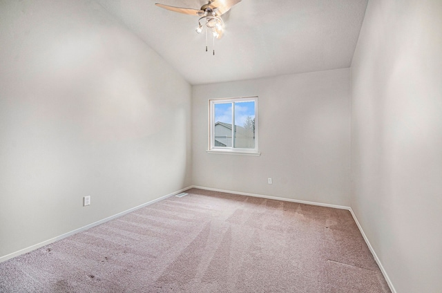 carpeted empty room with ceiling fan and lofted ceiling