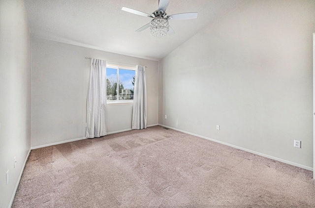 carpeted empty room with a textured ceiling, ceiling fan, and vaulted ceiling