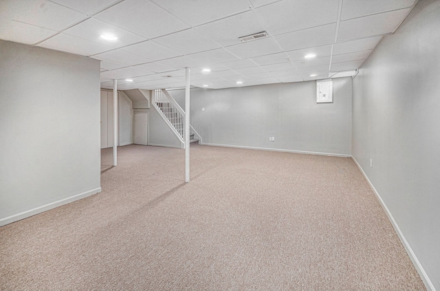 basement featuring carpet floors and a drop ceiling