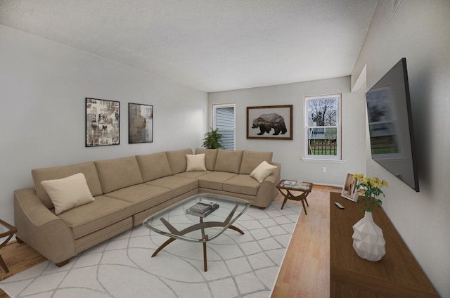 living room featuring light hardwood / wood-style flooring and a textured ceiling