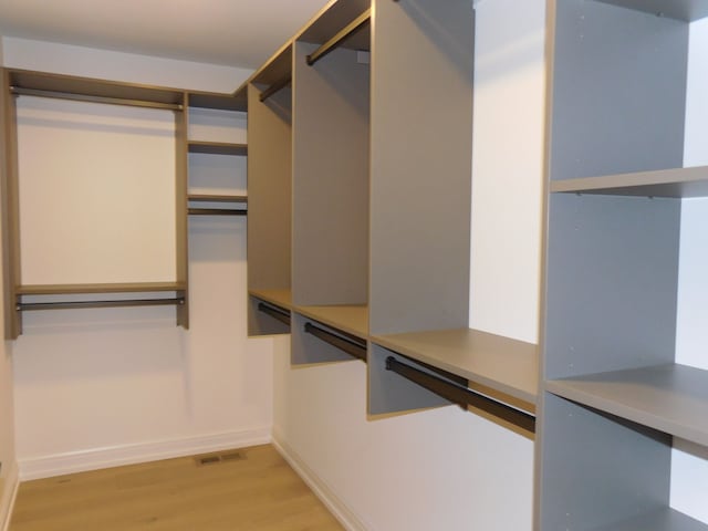 spacious closet with light wood finished floors and visible vents