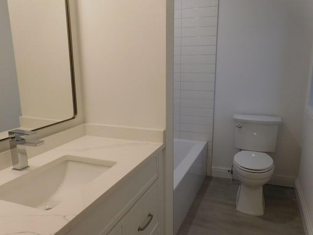 full bathroom with baseboards, vanity, and toilet