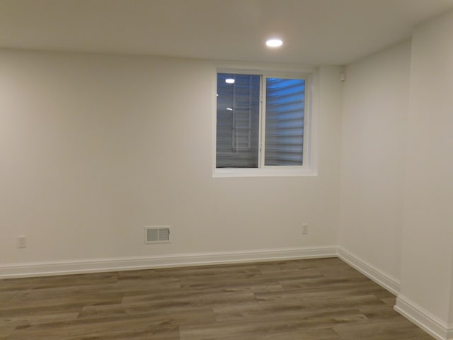 empty room featuring recessed lighting, visible vents, baseboards, and wood finished floors