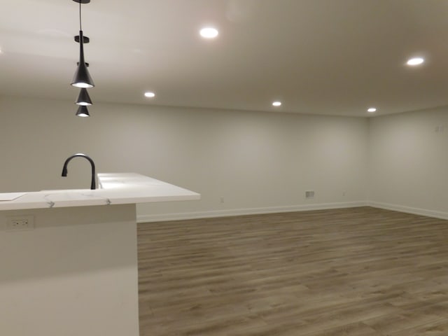 kitchen featuring recessed lighting, pendant lighting, baseboards, and wood finished floors