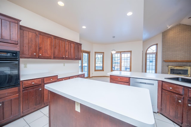 kitchen featuring pendant lighting, a kitchen island, black oven, and stainless steel dishwasher