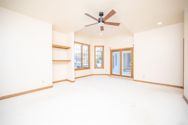 unfurnished living room featuring light colored carpet and ceiling fan