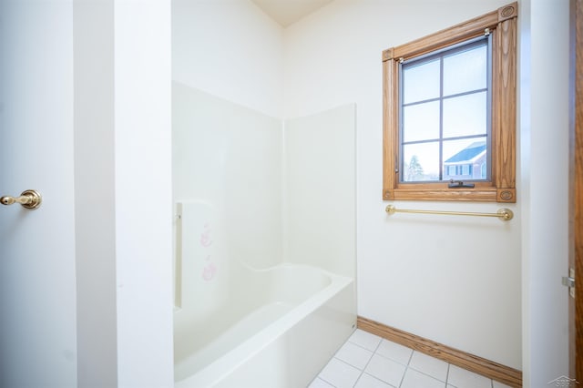 bathroom featuring tile patterned flooring and a washtub