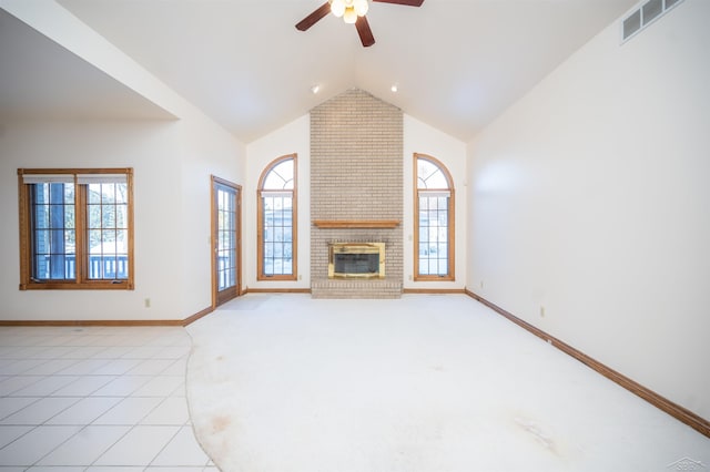 unfurnished living room featuring a fireplace, high vaulted ceiling, ceiling fan, and light tile patterned flooring