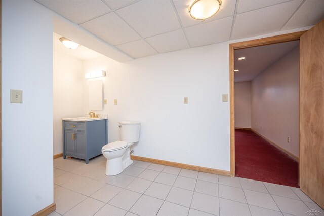 bathroom featuring vanity, a paneled ceiling, and toilet