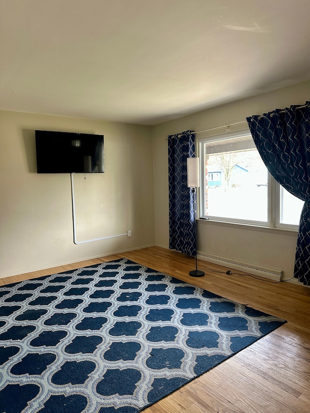 interior space featuring hardwood / wood-style flooring and baseboard heating