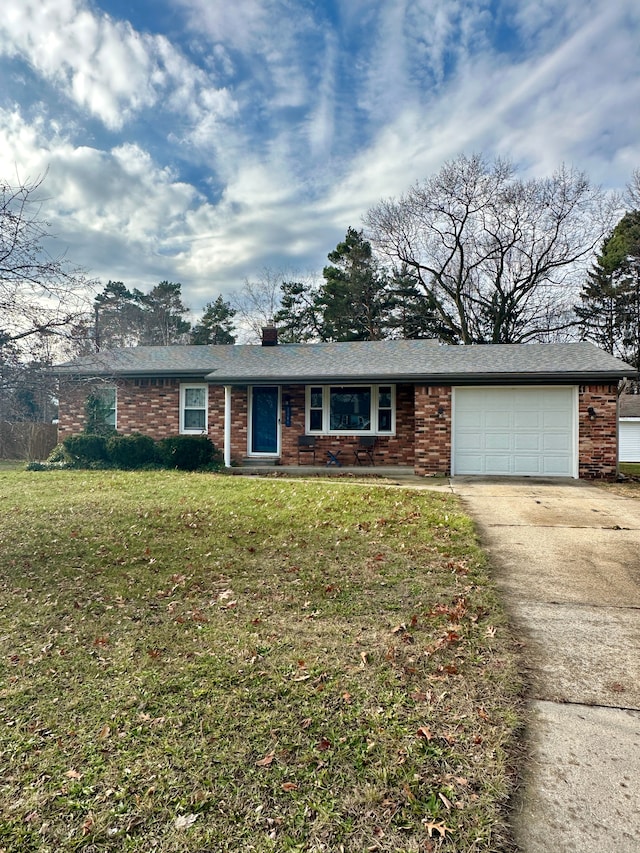 ranch-style house with a garage and a front lawn