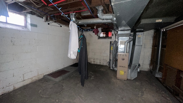 basement featuring heating unit and gas water heater