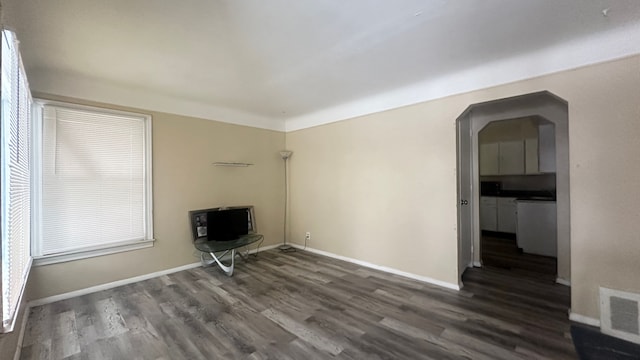 spare room with dark hardwood / wood-style flooring