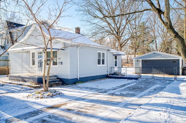 exterior space featuring a garage and an outbuilding