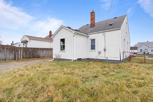 back of property featuring a yard