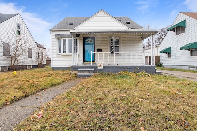 bungalow-style home with a front lawn