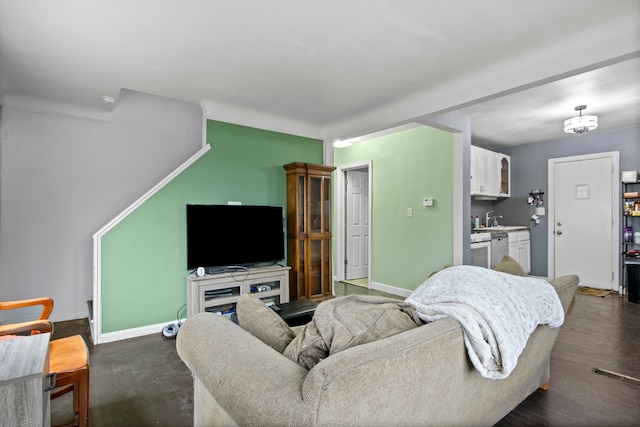 living room with sink and dark wood-type flooring