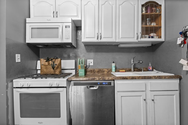 kitchen with sink, white cabinets, and white appliances