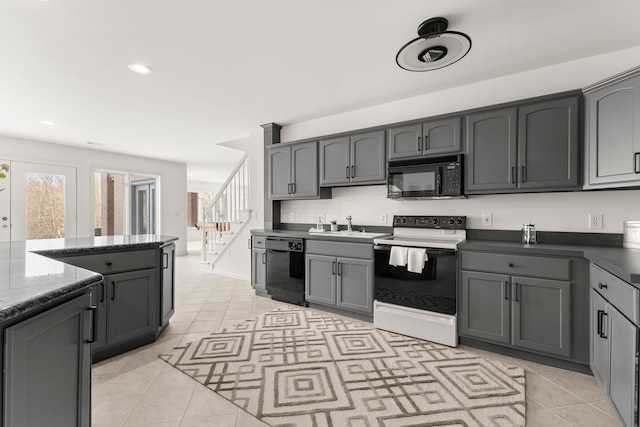 kitchen featuring gray cabinets, sink, light tile patterned flooring, and black appliances