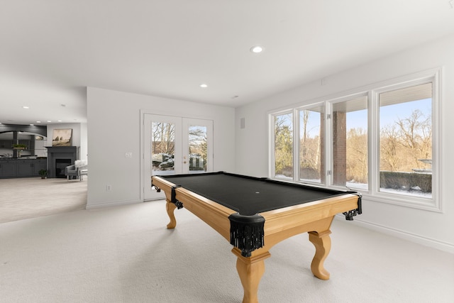 recreation room with light colored carpet, a healthy amount of sunlight, and pool table