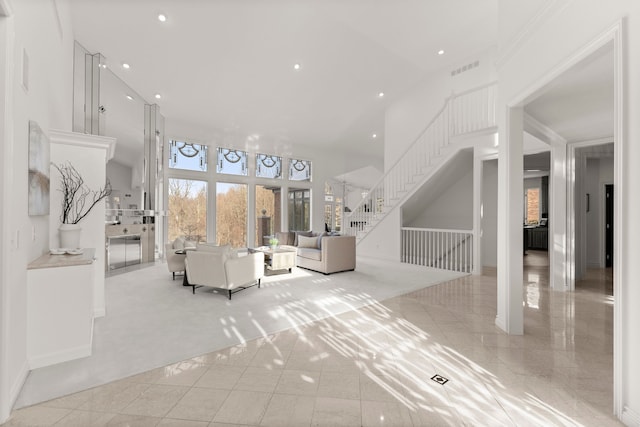 unfurnished living room featuring a high ceiling