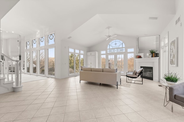 living room featuring ceiling fan, french doors, light tile patterned floors, and high vaulted ceiling