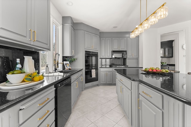 kitchen with dark stone counters, gray cabinets, and black appliances