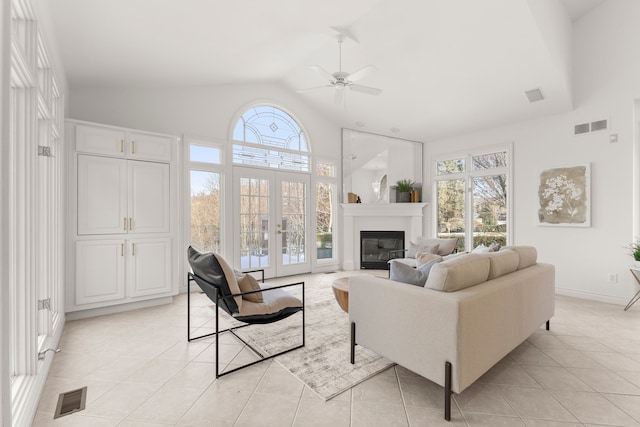 living room featuring ceiling fan, light tile patterned flooring, high vaulted ceiling, and french doors