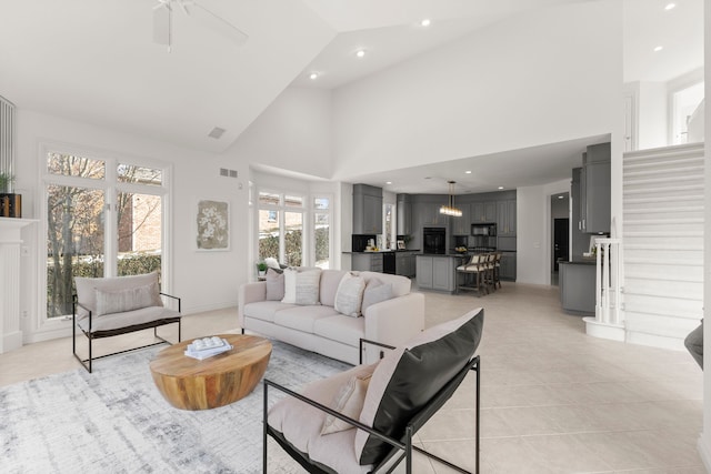 living room with high vaulted ceiling, ceiling fan, and light tile patterned flooring