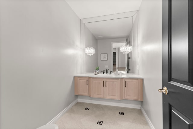 bathroom featuring vanity and a notable chandelier