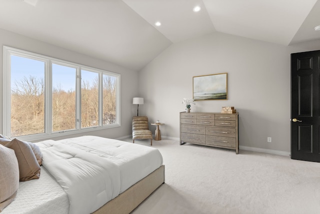 bedroom featuring light colored carpet and lofted ceiling