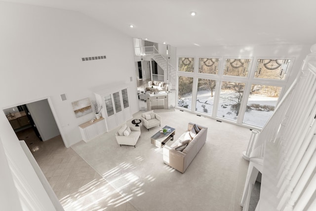 living room featuring light carpet and high vaulted ceiling