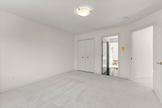 unfurnished room with light colored carpet