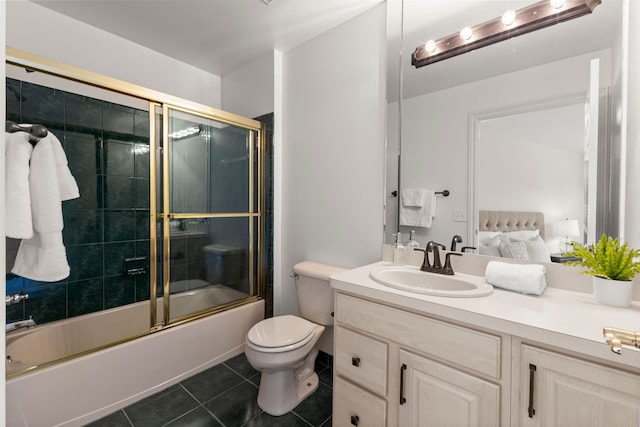 full bathroom with tile patterned flooring, vanity, toilet, and bath / shower combo with glass door