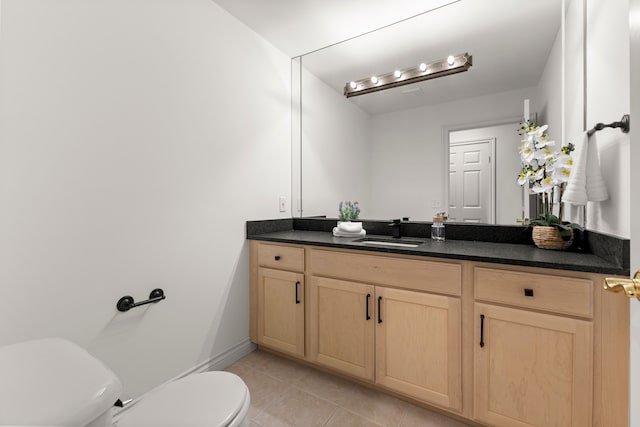 bathroom with tile patterned floors, vanity, and toilet