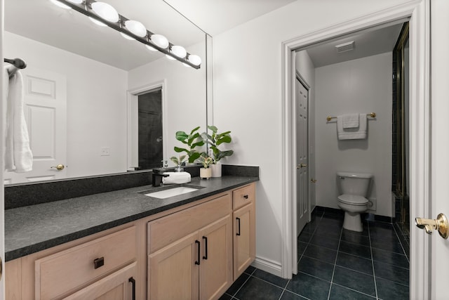 bathroom with tile patterned flooring, vanity, and toilet